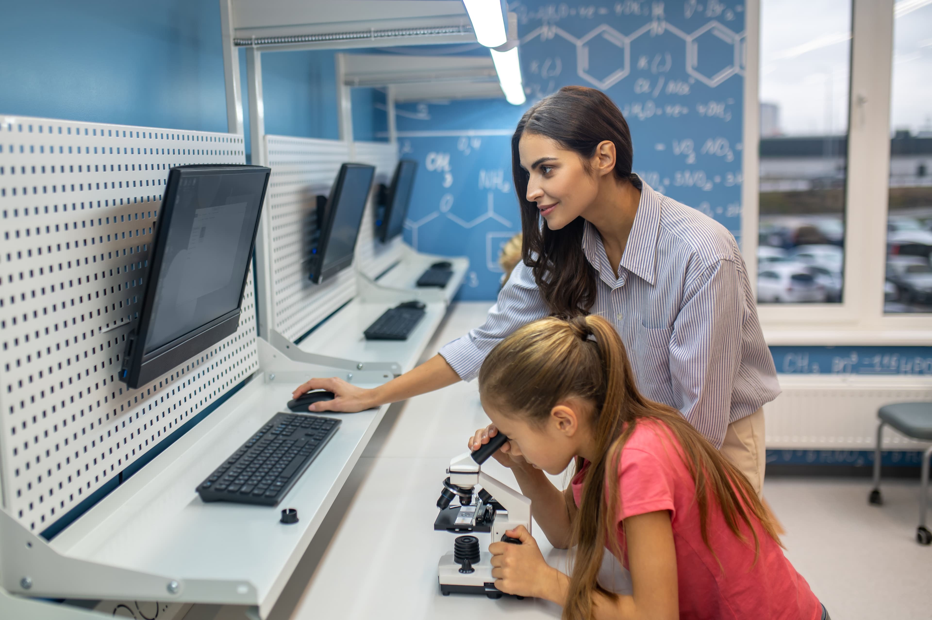 Teacher with Student carrying out a chemistry tutoring session